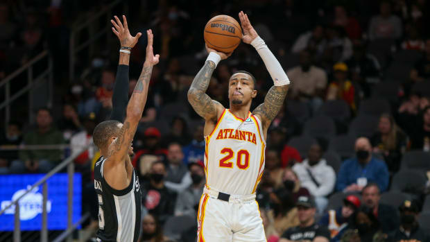 Atlanta Hawks forward John Collins (20) shoots over San Antonio Spurs guard Dejounte Murray (5) in the second half at State Farm Arena.